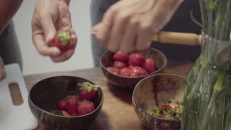 Cropped-shot-of-man-slicing-strawberries